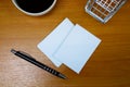 Stacked paper of blank white business cards mockup with an elegant black pen on the wooden table background. Royalty Free Stock Photo