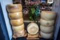 Stacked Parmigiano Reggiano forms, the most famous Italian cheese on sale in a shop.
