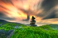 Stacked Pebbles art on mossy rocks