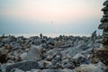 Stacked pebbles on the beach at sunset