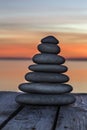 Stacked pebbles on a wooden surface