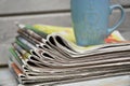 Stacked and piled up newspapers on a wooden table background Royalty Free Stock Photo