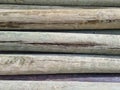 Stacked pine logs treated for mold, fungus and rot. Poles for equipment. Low quality lumber. Selective focus Royalty Free Stock Photo