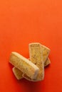 Stacked Pistachio cookies or butter Pista bakery cookies, on orange background.