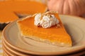 Stacked plates with piece of fresh homemade pumpkin pie with whipped cream on table Royalty Free Stock Photo