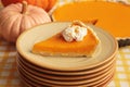 Stacked plates with piece of fresh homemade pumpkin pie with whipped cream on table Royalty Free Stock Photo