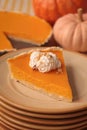 Stacked plates with piece of fresh homemade pumpkin pie with whipped cream on table Royalty Free Stock Photo