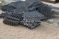 Stacked polymer geogrid panels for soil stabilization on sandy ground. For erosion control, road construction, and permeable Royalty Free Stock Photo