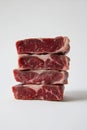 Stacked Raw Beef Steaks Isolated Against a Bright White Background Royalty Free Stock Photo