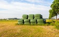 Stacked rectangular bales  of hay wrapped with green plastic film Royalty Free Stock Photo