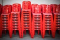 Stacked red plastic chairs in rows Royalty Free Stock Photo
