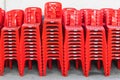 Stacked red plastic chairs in rows Royalty Free Stock Photo