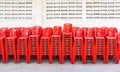 Stacked red plastic chairs in rows Royalty Free Stock Photo