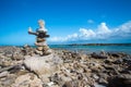 Stacked rocks balance on rocky beach in Aruba