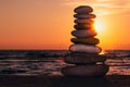 Stacked rocks on the beach with a sunset ocean Royalty Free Stock Photo