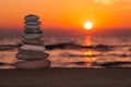 Stacked rocks on the beach with a sunset ocean Royalty Free Stock Photo