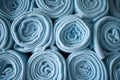 Stacked rolled blue blankets