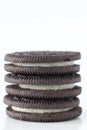 Stacked sandwich cookies on white background with negative space for copy