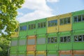 Stacked school containers, green orange and yellow, outsourced education