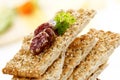 Stacked sesame crispbread with slices of salami Royalty Free Stock Photo