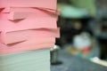 Stacked sheets of colored paper on workspace desk Royalty Free Stock Photo