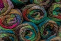 Stacked skeins of colorful rustic yarn, carded and drawn, creative copy space background for fiber crafts Royalty Free Stock Photo