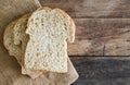 Stacked slice whole wheat sandwich bread on gunny sack cloth on wood table