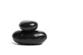 Stacked smooth black stones. Sea pebble. Balancing wet pebbles isolated on white background Royalty Free Stock Photo