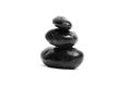 Stacked smooth black stones. Sea pebble. Balancing wet pebbles isolated on white background Royalty Free Stock Photo