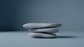 Stacked Smooth Gray Stones on a Minimalist Blue Background Royalty Free Stock Photo