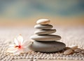 Stacked smooth zen stones. Balancing pebbles with flower