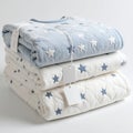 Stacked soft blankets with star patterns in pastel hues, perfect for baby on white background Royalty Free Stock Photo
