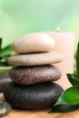 Stacked spa stones and bamboo leaves on mat, closeup Royalty Free Stock Photo