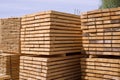 Stacked stacks of wooden planks. Lumber warehouse, wood drying.