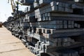 Stacked steel bars for construction projects, industrial metal supplies at warehouse lot, infrastructure materials.