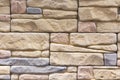 Stacked stone wall, natural stone cladding. Stone wall for background,Slab stone wall texture. Wall background of volcanic Royalty Free Stock Photo