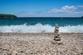 Stacked stones and crashing waves on school house beach in door County Wisconsin