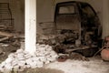 Stacked stones near a pillar with a broken down pick up vehicle on the back with vintage looks