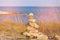 Stacked stones over ocean skyline