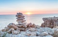 Stacked stones over the sea at sunset Royalty Free Stock Photo