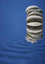 Stacked Stones Refelcting in Blue Water Royalty Free Stock Photo