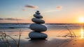 Stacked stones on a serene beach at sunset with waves gently rolling in the background Royalty Free Stock Photo