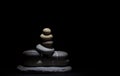 Stacked Stones under a soft light on a black background Royalty Free Stock Photo