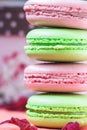 Stacked, tasty pink and green Macaroons, colorful delicious French pastries, strawberry and pistachio macaroons