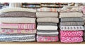 Stacked textiles, shop display, yarn shelves, fabric patterns, retail