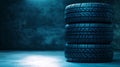Stacked tires in a dimly lit warehouse showcasing detailed tread patterns Royalty Free Stock Photo