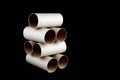 Stacked Toilet Paper Cardboard Tubes on Black Royalty Free Stock Photo