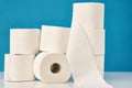 Stacked toilet paper rolls on a blue background. Hygiene concept Royalty Free Stock Photo