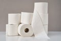 Stacked toilet paper rolls on a gray background. Hygiene concept Royalty Free Stock Photo