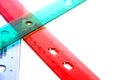 Stacked transparent pink, green and red plastic rulers isolated on a white background with room for text Royalty Free Stock Photo